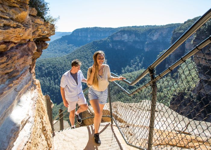 Couple enjoying a walk along the Wentworth Falls Track in the Blue Mountains National Park.
