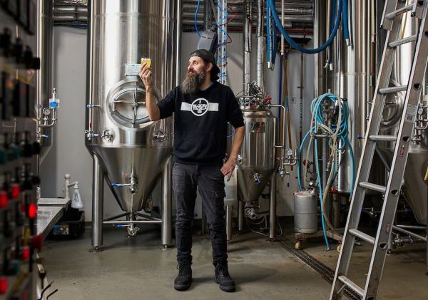 Block n Tackle, Kincumber - Credit: Block n Tackle Man holding a beer in the brewery at Block n Tackle, Kincumber